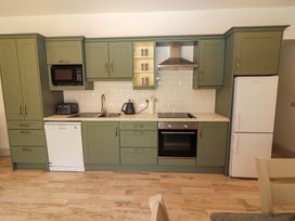A kitchen with appliances and cabinets at Teach Ti in Miltown Malbay