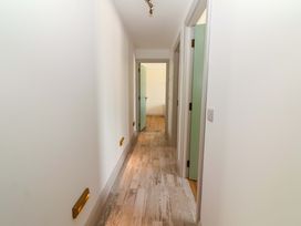 A hallway with doors and a light fixture at Teach Ti in Miltown Malbay
