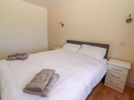 A bedroom with a double bed and bedside table at Teach Ti in Miltown Malbay