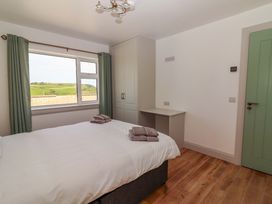 A bedroom with a bed and window at Teach Ti in Miltown Malbay