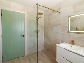 A bathroom with a shower and sink at Teach Ti in Miltown Malbay