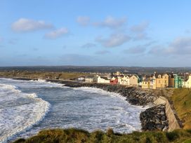 A coastal view with houses along the shore at Teach Ti in Miltown Malbay