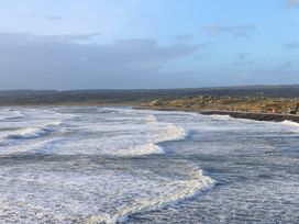 A view of the ocean with waves and shoreline at Teach Ti Miltown Malbay