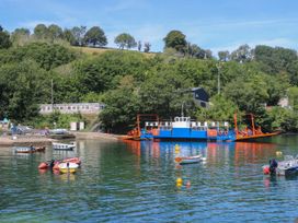A ferry and small boats at a dock in Fowey