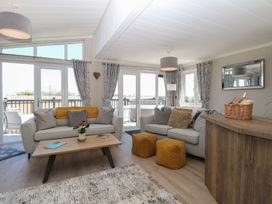 A living room with a sofa and coffee table at Life's a Beach in Bacton