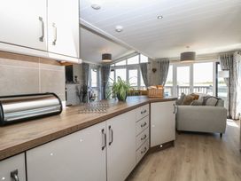 A kitchen with a countertop and dining area at Life's a Beach in Bacton
