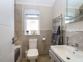 A bathroom featuring a toilet, sink, and bathtub at Life's a Beach in Bacton