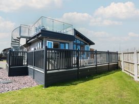 A house with a deck and staircase in an outdoor area at Life's a Beach Bacton