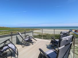 A deck with chairs overlooking the ocean at Life's a Beach in Bacton