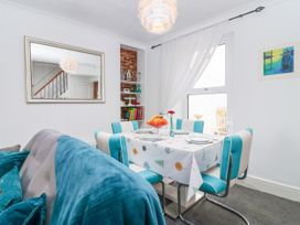 A dining room with a table and chairs at 45 North View Brixham