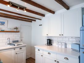 A kitchen with cabinets and a stove at 45 North View in Brixham