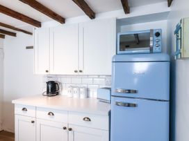A kitchen with a blue refrigerator and kettle at 45 North View Brixham