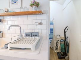 A kitchen with a sink and dish rack at 45 North View in Brixham
