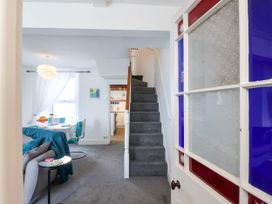 A living room with a staircase and dining area at 45 North View Brixham