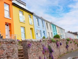 Row of colorful houses with wall and steps at 45 North View Brixham