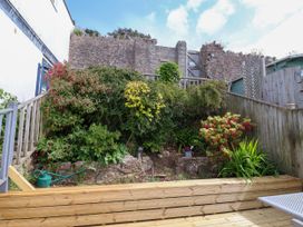 A garden with flowers and wooden decking at 45 North View in Brixham