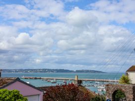 A view of a harbor with boats and a pier at 45 North View in Brixham