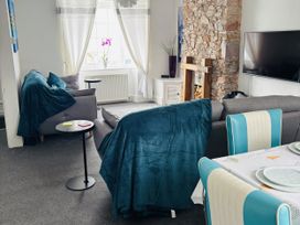 A living room with a sofa and coffee table at 45 North View in Brixham