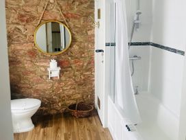 A bathroom with a shower and bathtub at Lizzy’s Cottage in Brixham