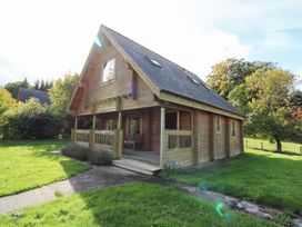 A wooden house with a porch and windows at Pen Y Clawdd near Beggar's Bush, Presteigne