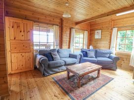 A living room with two sofas and a coffee table at Pen Y Clawdd near Beggar's Bush