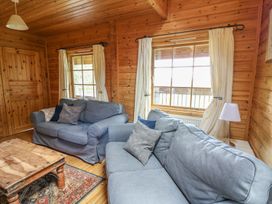 A living room with two sofas and a wooden table at Pen Y Clawdd near Beggar's Bush, Presteigne