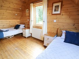 A bedroom with two beds and a window at Pen Y Clawdd near Presteigne