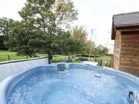 An outdoor area with a hot tub and seating at Pen Y Clawdd Beggar's Bush near Presteigne
