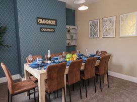 A dining room with a table set for dinner at Crescent Bay House