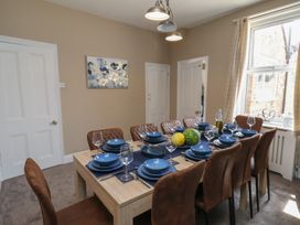 A dining room with a table set for dinner at Crescent Bay House
