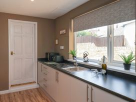 A kitchen with a sink and cabinets at Crescent Bay House