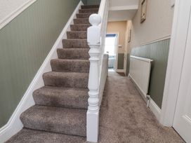 A staircase and hallway at Crescent Bay House