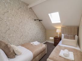 A bedroom with two beds and a lamp at Crescent Bay House in 