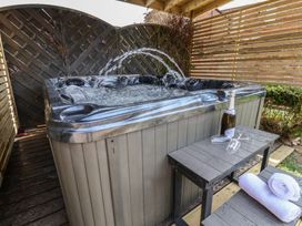 A hot tub with champagne and glasses on a table at Crescent Bay House