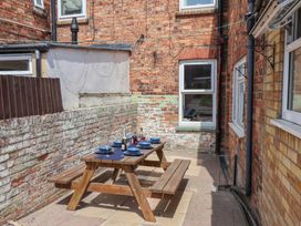 An outdoor dining area with a table set at Crescent Bay House