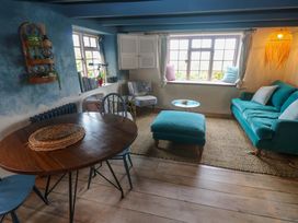 A living room with a table and chairs at Mermaid Cottage in Coverack near St Keverne