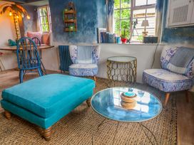 A living room with a sofa and armchairs at Mermaid Cottage in Coverack near St Keverne