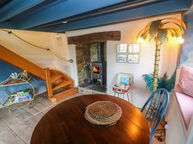 A living room with a wooden table and a record player at Mermaid Cottage in Coverack near St Keverne