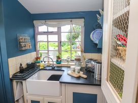 A kitchen with a sink and window at Mermaid Cottage in Coverack near St Keverne