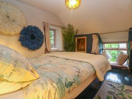 A bedroom with a bed and window at Mermaid Cottage in Coverack near St Keverne