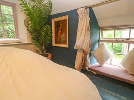 A bedroom with a bed and window at Mermaid Cottage in Coverack near St Keverne