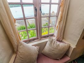 A window with cushions and sea view at Mermaid Cottage in Coverack near St Keverne