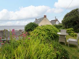 A garden with flowers and seating at Mermaid Cottage in Coverack near St Keverne