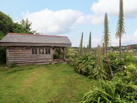 A shed in a garden with plants at Mermaid Cottage in Coverack near St Keverne