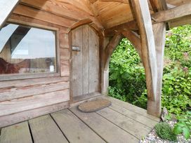 An outdoor area with a wooden structure and door at Mermaid Cottage in Coverack near St Keverne