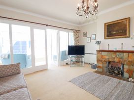A living room with a television and a fireplace at 22 Pentire Avenue Newquay
