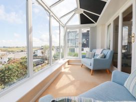 A conservatory with a sofa and views at 22 Pentire Avenue Newquay