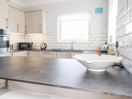 A kitchen with cabinets and appliances at 22 Pentire Avenue in Newquay