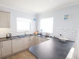 A kitchen with cabinets, sink, and countertop at 22 Pentire Avenue in Newquay