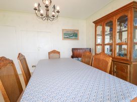 A dining room with a table and chairs at 22 Pentire Avenue in Newquay